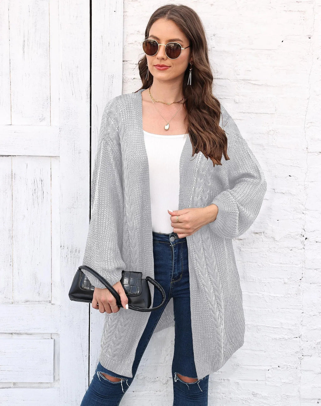 Women's loose acrylic sweater coat in solid colour on hanger