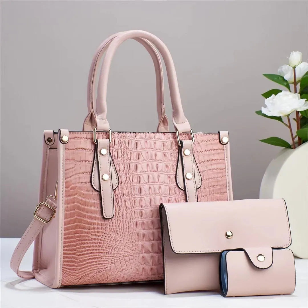 Women's textured PU leather three-piece travel bag set showing crossbody bag, wallet and card holder in coordinated colour