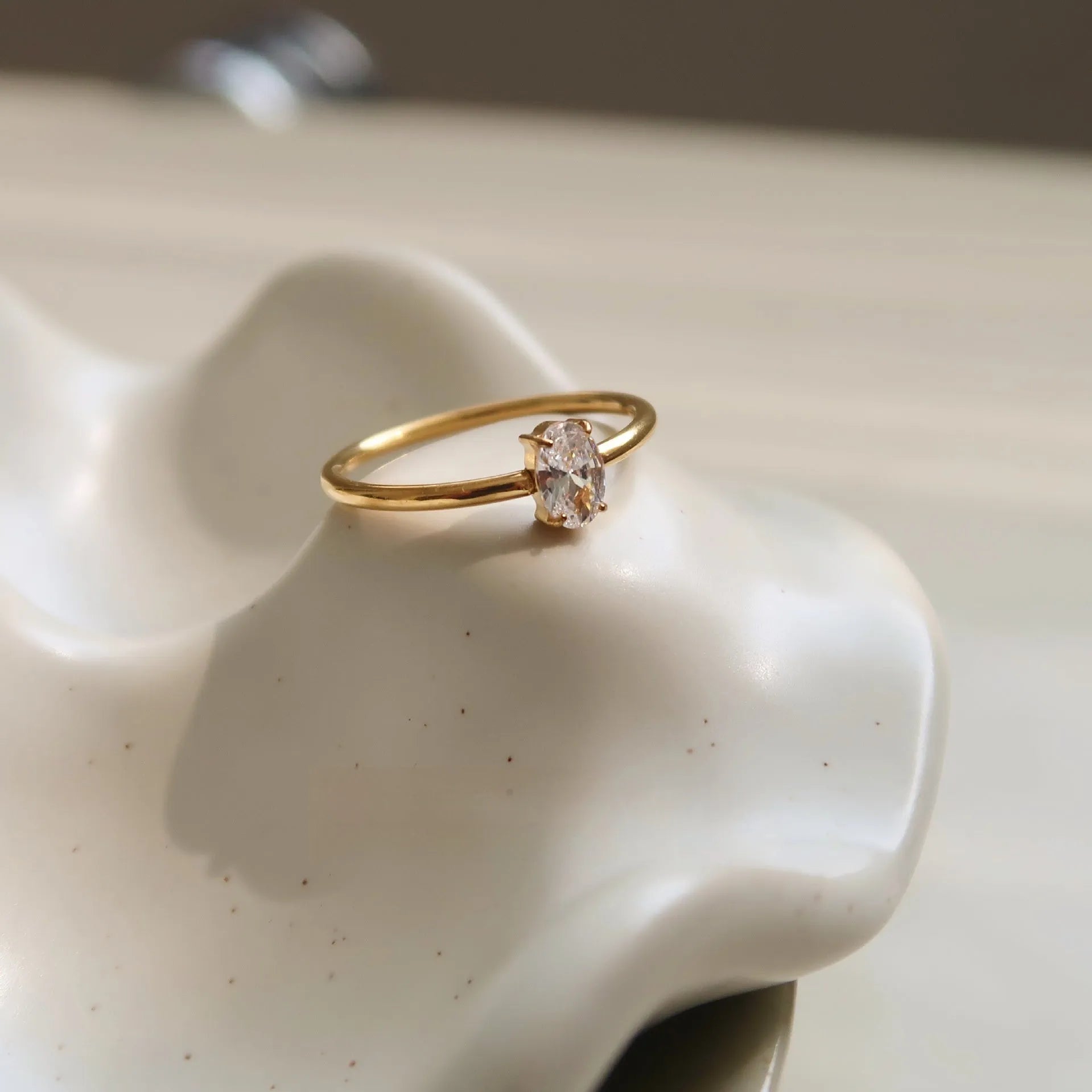 Golden stainless steel ring showing love heart and oval design options on a white background.