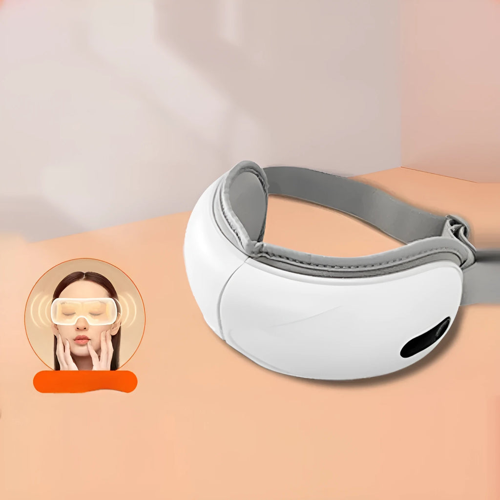 White rechargeable eye massager with heat and air compression therapy on a grey background.