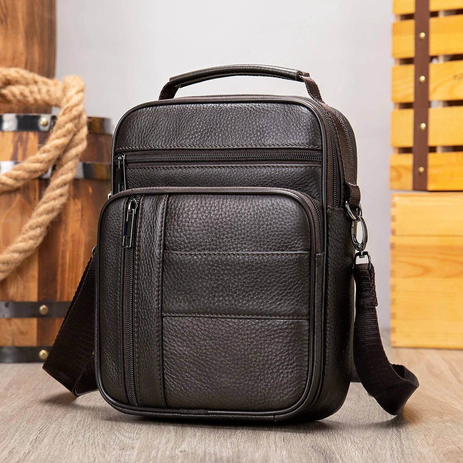 Men's vintage style genuine leather shoulder bag in a square shape with multiple internal pockets.