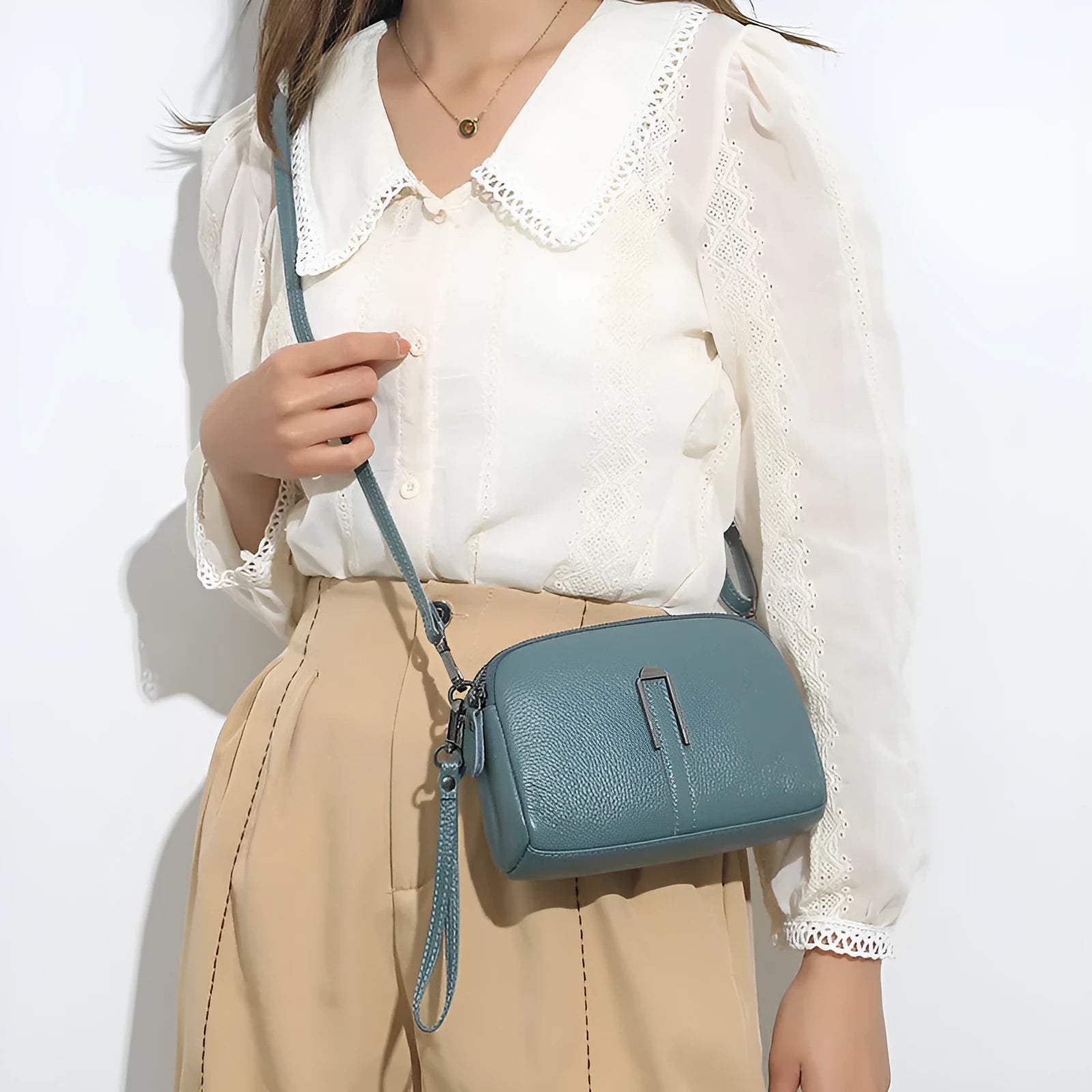 Genuine leather women's square shoulder bag in dark green, showing its horizontal 19x13x6cm shape.