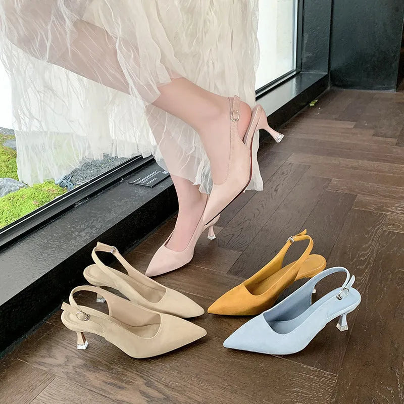 Apricot suede stiletto high heels with a pointed toe and rubber sole on a plain background.