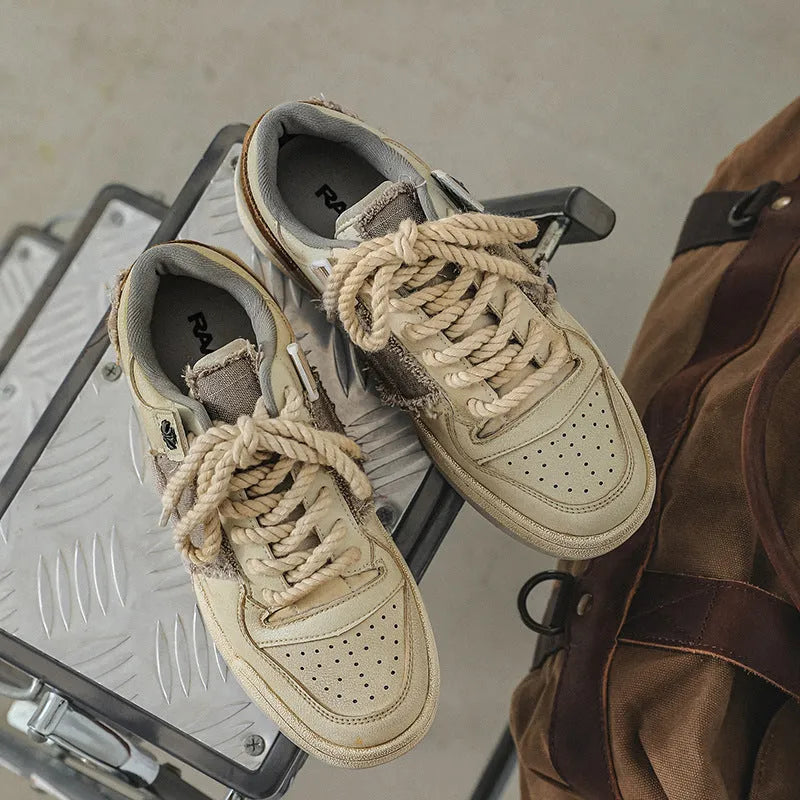 Beige low-top casual skateboard shoes with round toe and front lace-up on a rubber sole.