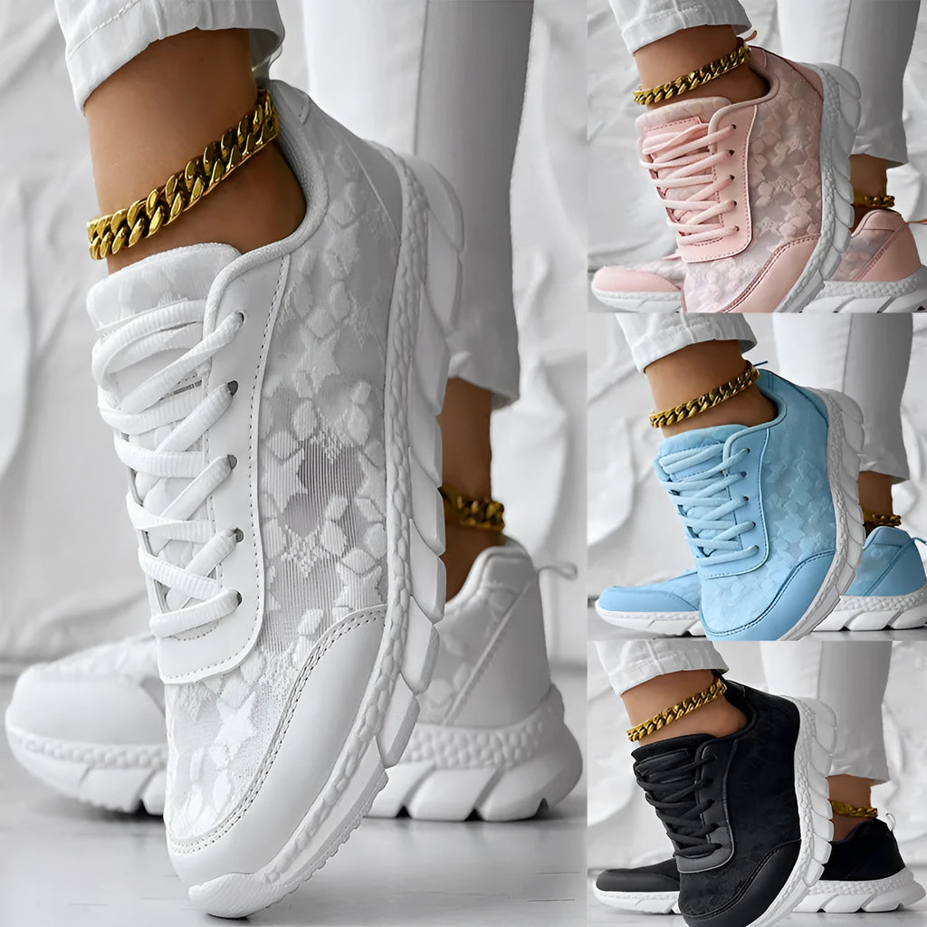 Women's white canvas casual running shoes with flat heel and round toe on a plain background.