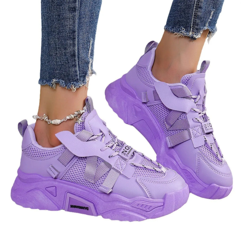 Women's purple platform sneaker with breathable mesh upper and lace-up front on a neutral background.