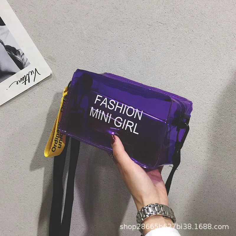 Transparent square women's shoulder bag in jelly material with a diagonal cross strap, showing internal mobile phone pocket.