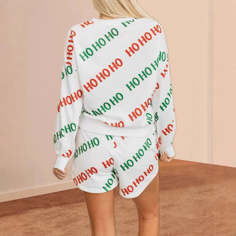 Women's white two-piece suit with printed letter pattern showing long sleeves and fifth-length trousers