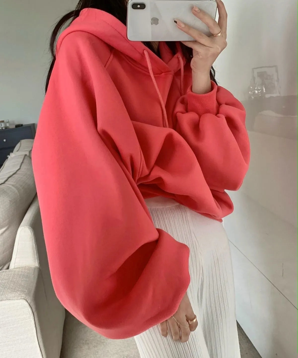 Watermelon red women's loose fit mulberry silk hooded sweater on a hanger.