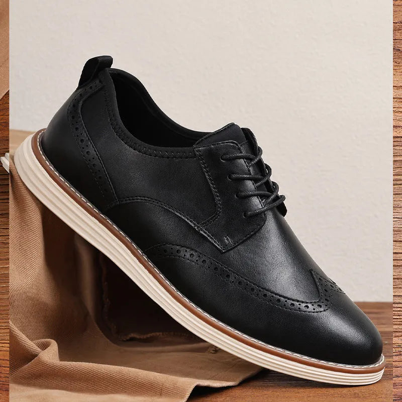 Men's black slip-on business casual shoes with round toe and carved sole detail on a white background.