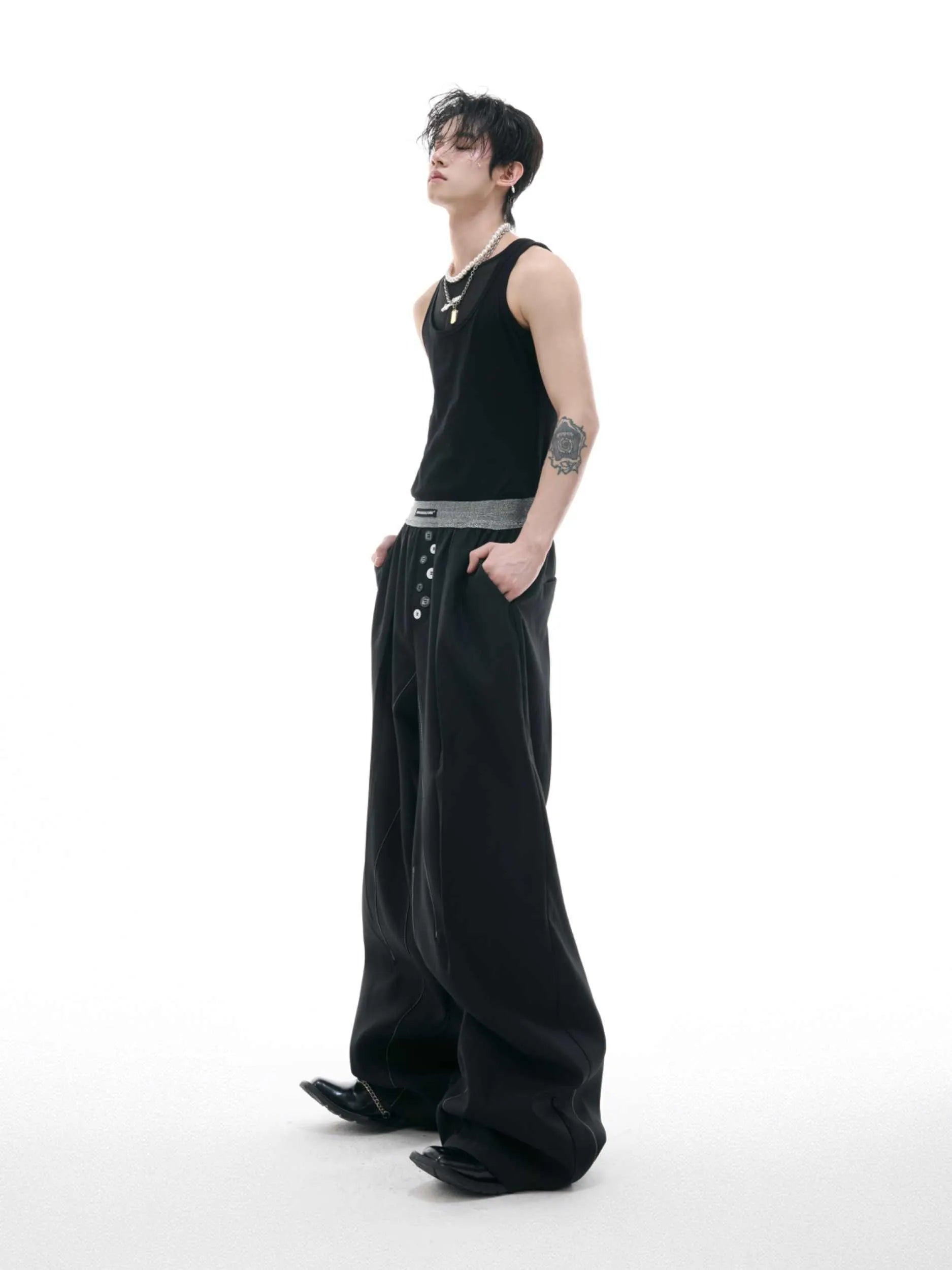 Straight-leg high-waist trousers with button-fly front opening in black or grey
