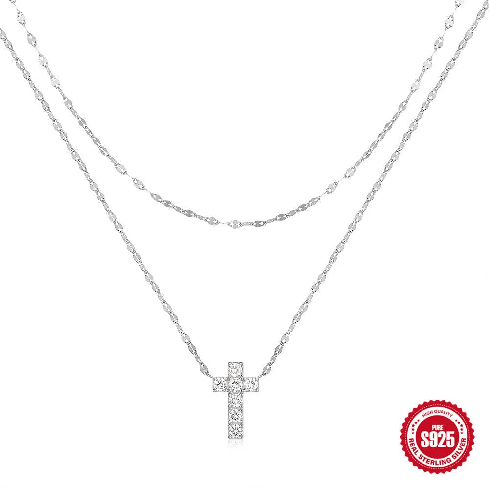 S925 sterling silver double layer twin diamond cross pendant necklace on a clavicle chain, shown in gold and white gold colour finishes.