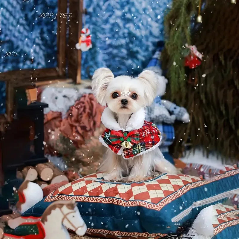 Pet wearing red Christmas cloak with bell design, draped over back with festive snowflake pattern