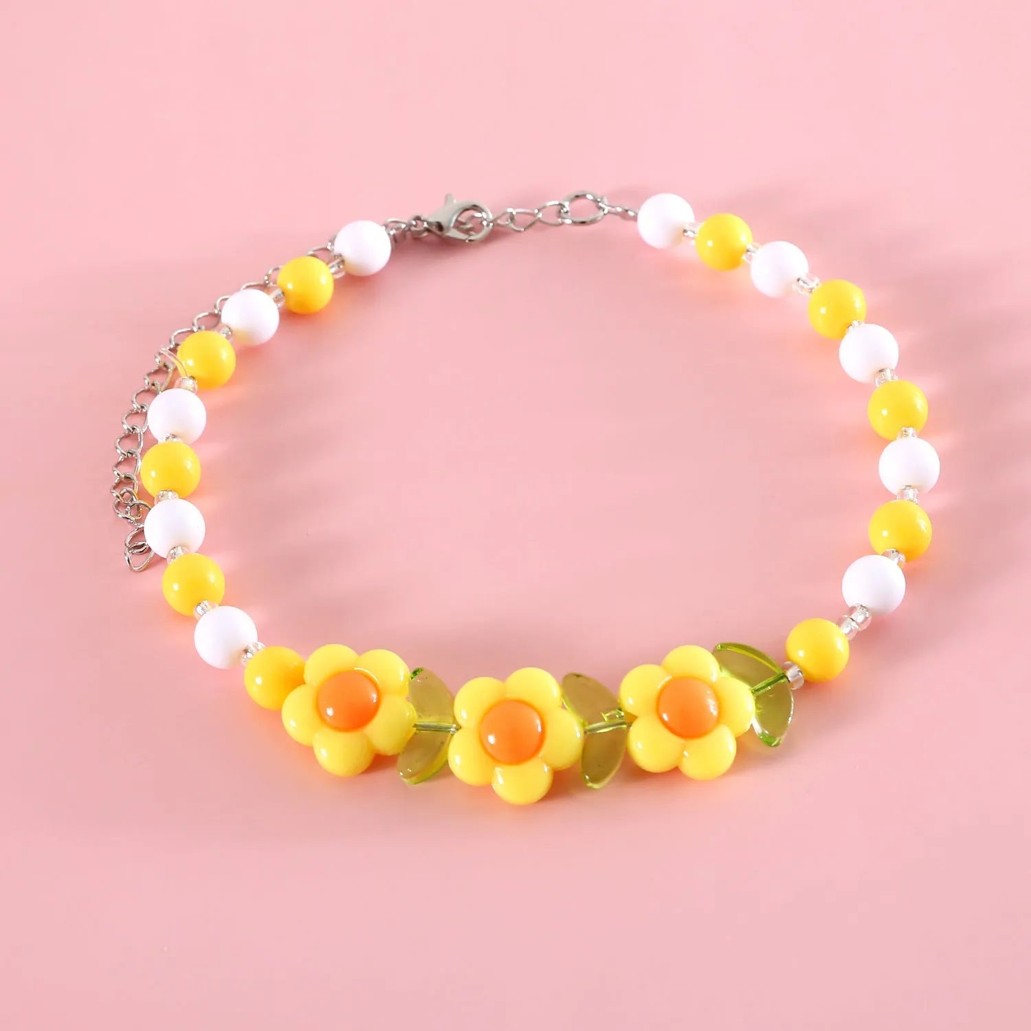 Colourful plastic bead cat necklace in small flower, rainbow, or peach design on a cat.