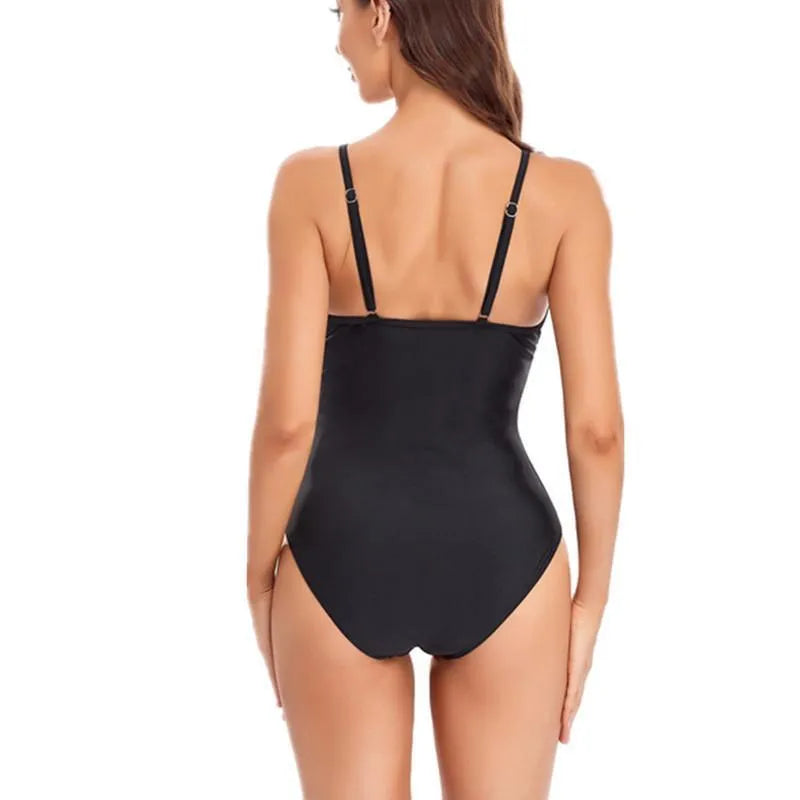 Black solid colour backless one-piece swimsuit laid flat.