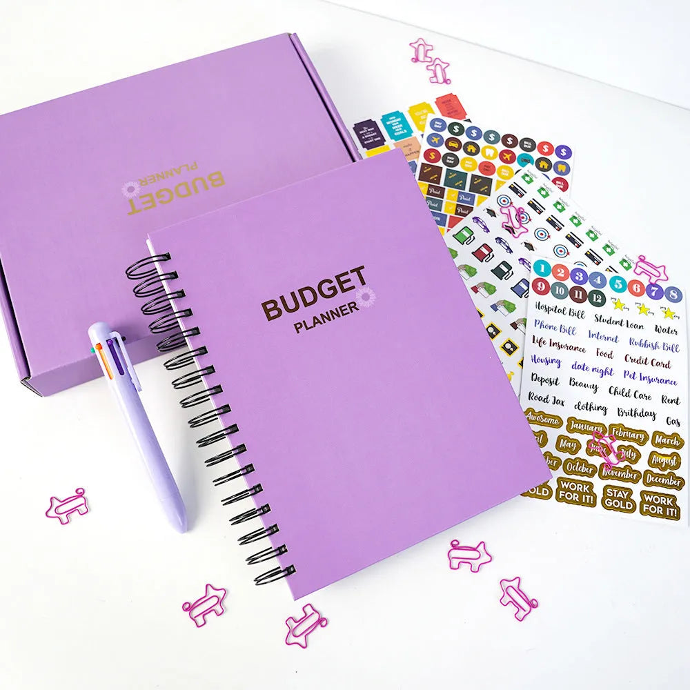 A5 purple budget notebook with coil binding, stickers, pen, and paper clips for financial planning
