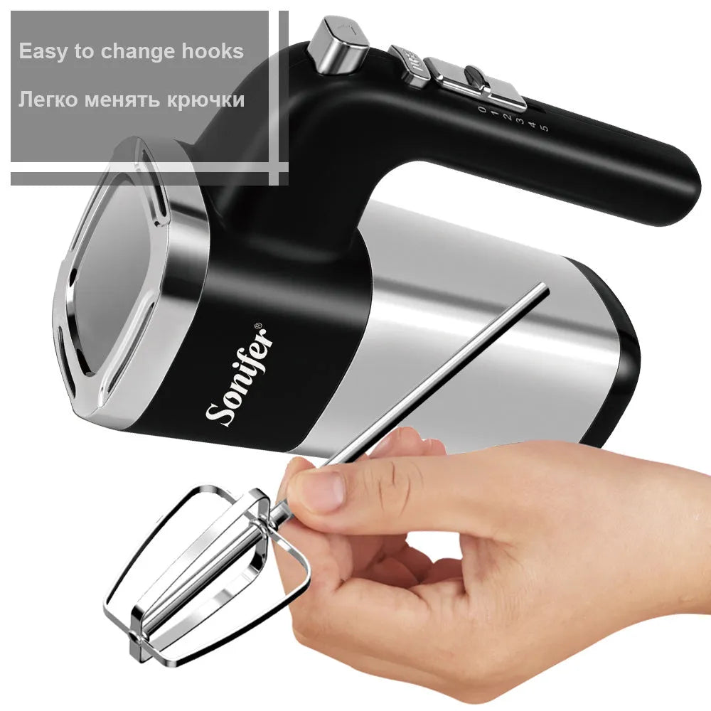 White 500W 5-speed electric hand mixer with beaters and dough hooks on a kitchen counter