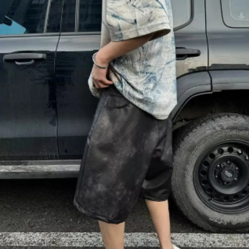 Korean style loose fit T-shirt with a full printed tie dye design on a solid colour background.