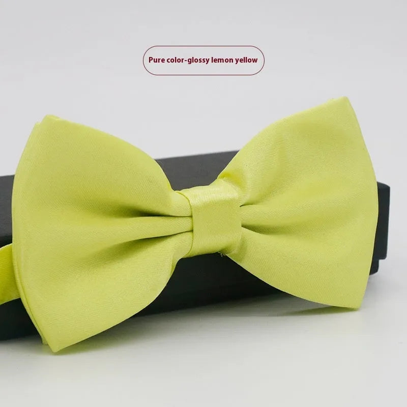 Men's flat head style polyester bow tie in a solid colour, shown with adjustable neck strap.
