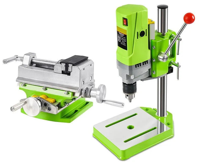 Mini bench drill milling machine with AC power supply and included bench pliers on workbench
