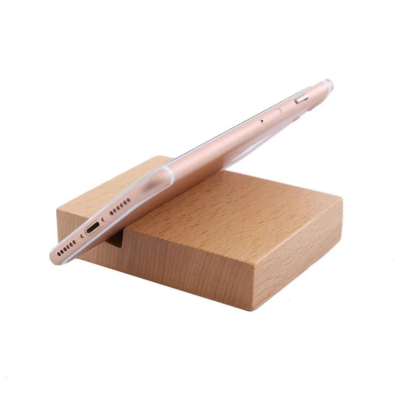 Beech wood mobile phone holder stand with coin slot and decorative carving.