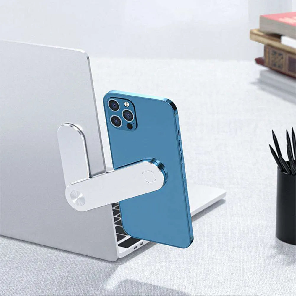 Black magnetic laptop phone holder with foldable aluminium bracket attached to a laptop screen