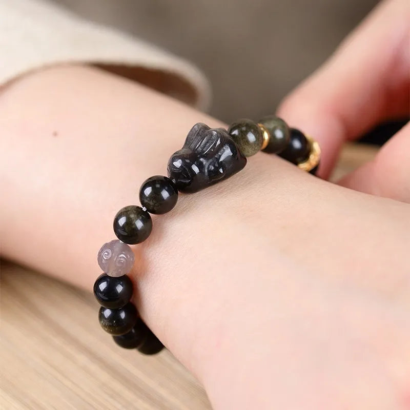 Handmade national style obsidian bracelet with a detailed lying rabbit centrepiece in jin yaoshi and grey agate.