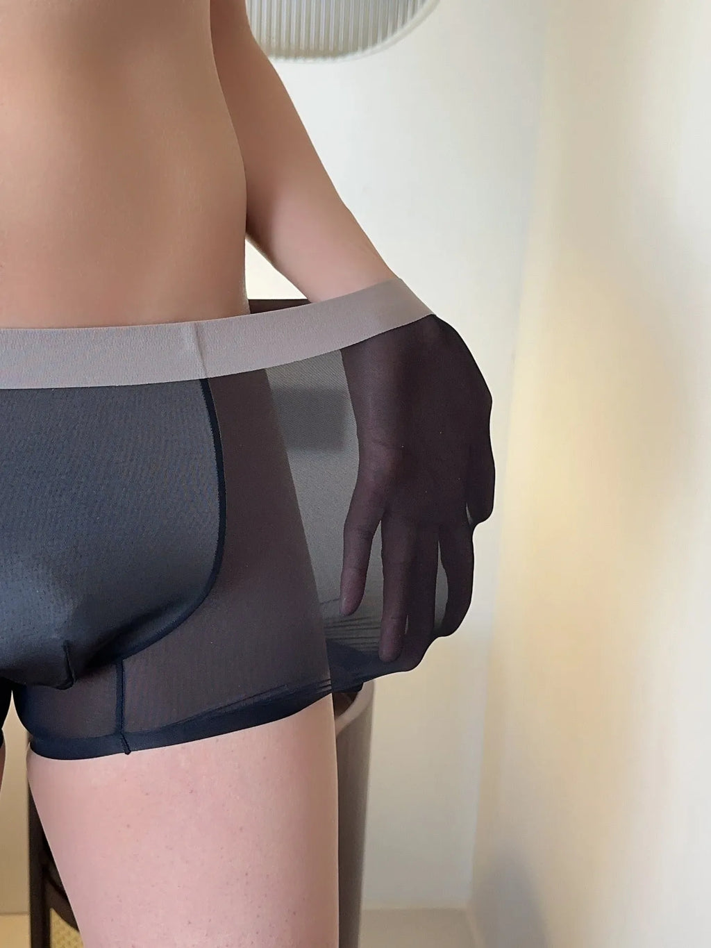 Ultra-thin seamless men's boxer shorts showing honeycomb crotch detail in ice silk fabric.