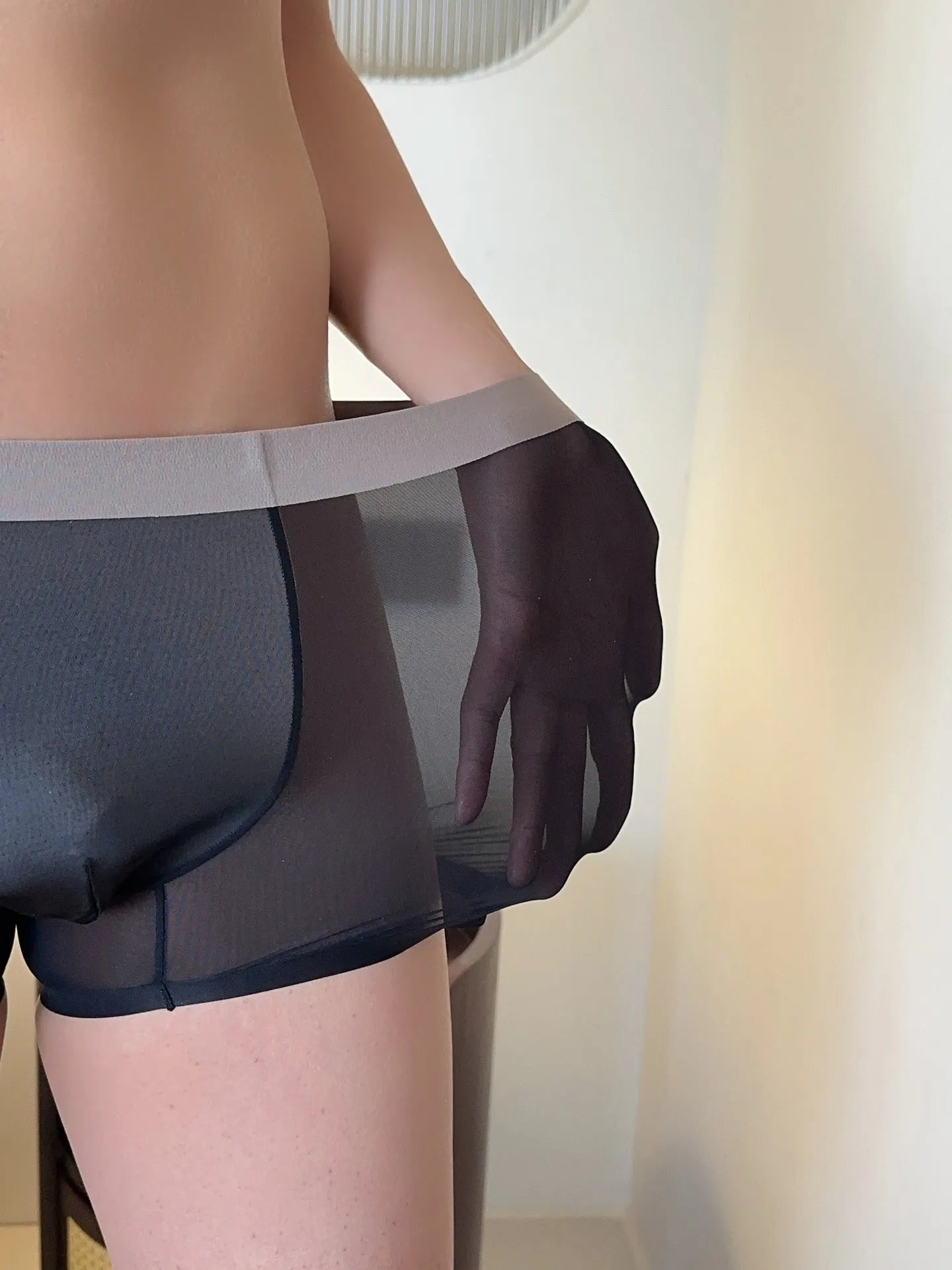 Ultra-thin seamless men's boxer shorts showing honeycomb crotch detail in ice silk fabric.