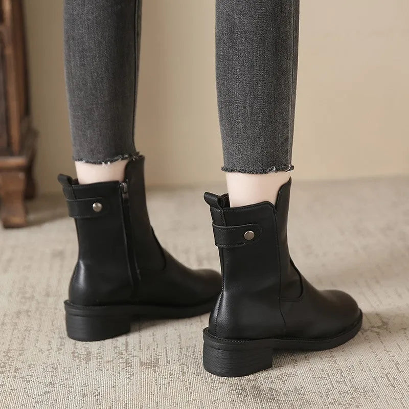 Black women's ankle boots with a round toe, side zip, and a low rubber sole.