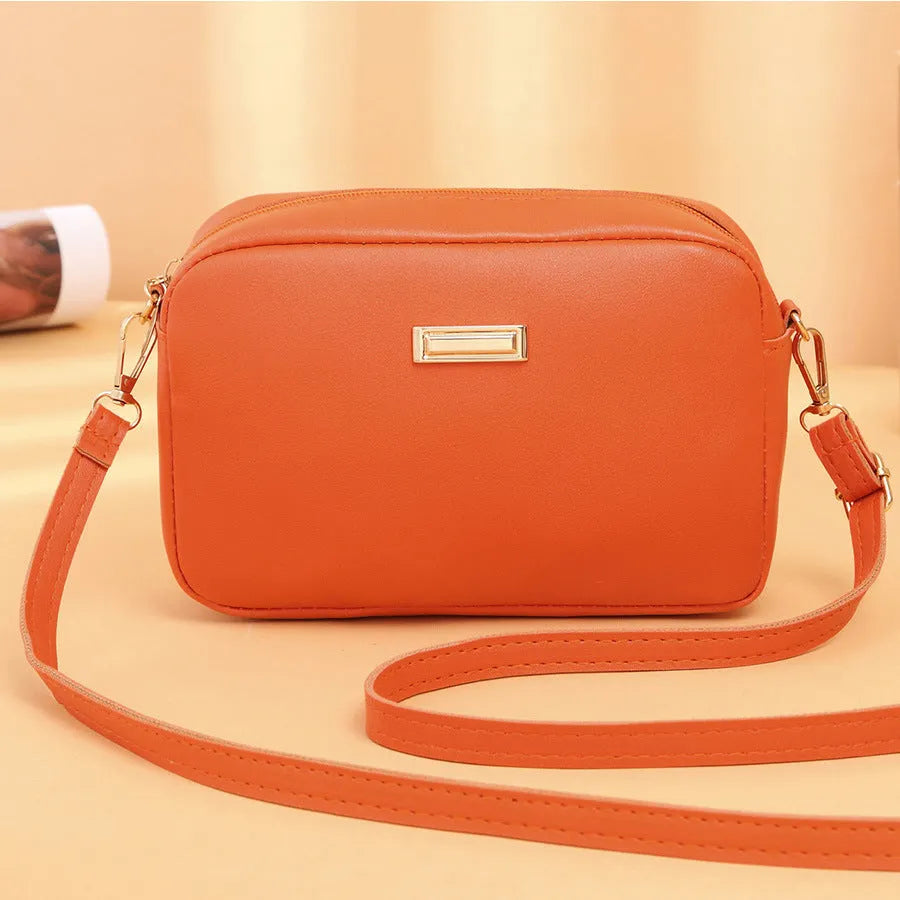 Women's solid colour PU leather shoulder bag with three-dimensional pocket and square shape.