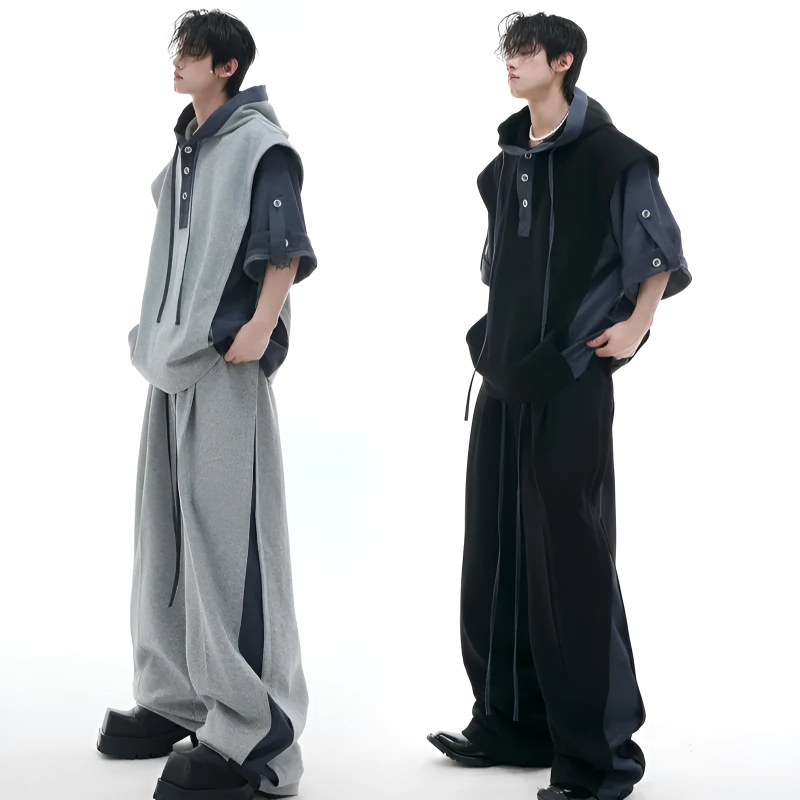 Men's black polyester sports suit with hooded short sleeve jacket and matching trousers laid flat