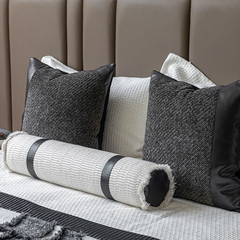 Modern minimalist plaid bed runner set with blanket, pillowcase, and round leather pillow on a bed
