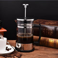 Manual glass and stainless steel pour-over coffee maker with 350ml capacity.