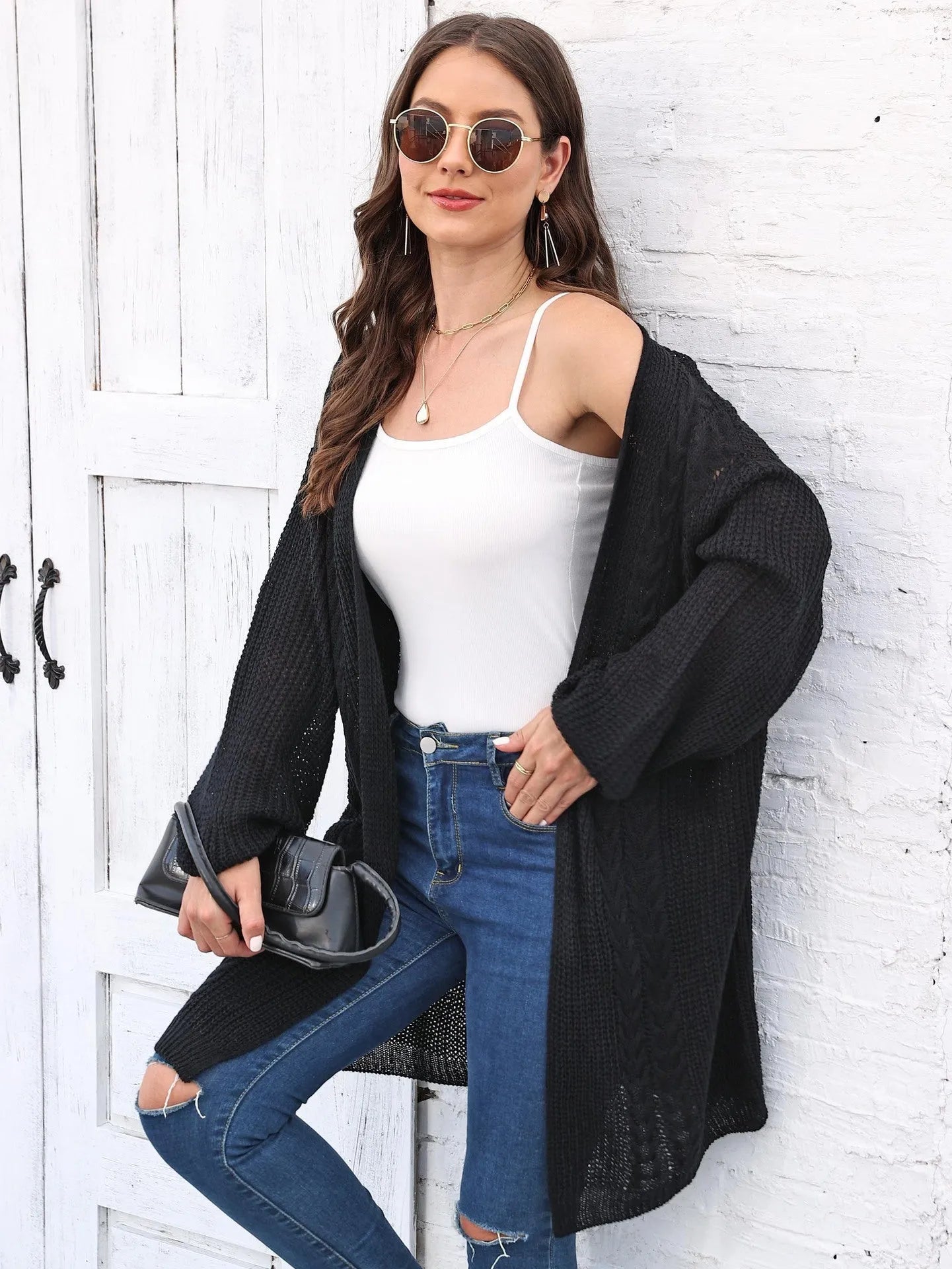 Women's loose acrylic sweater coat in solid colour on hanger