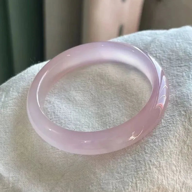Natural agate wide tyre bracelet showing colour variations including pink, white, blue and green options