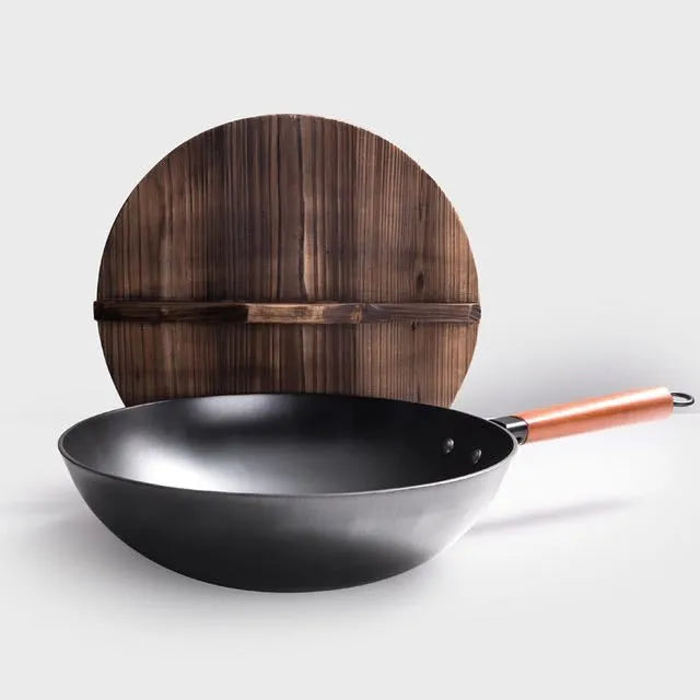 Traditional handmade iron wok pan with wooden handle and induction-compatible base