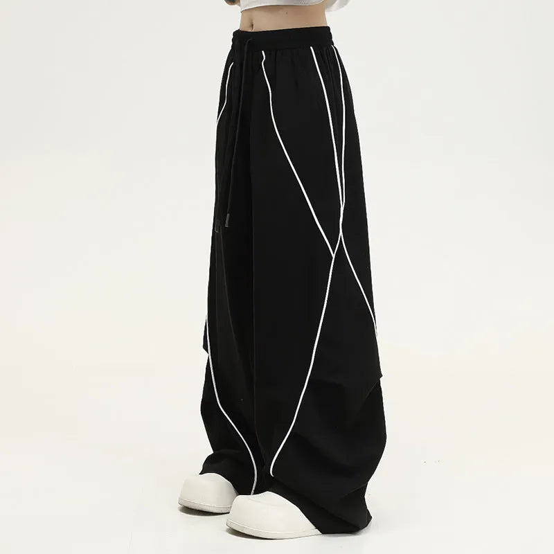 Black striped pleated hip hop wide-leg trousers with mid waist on mannequin