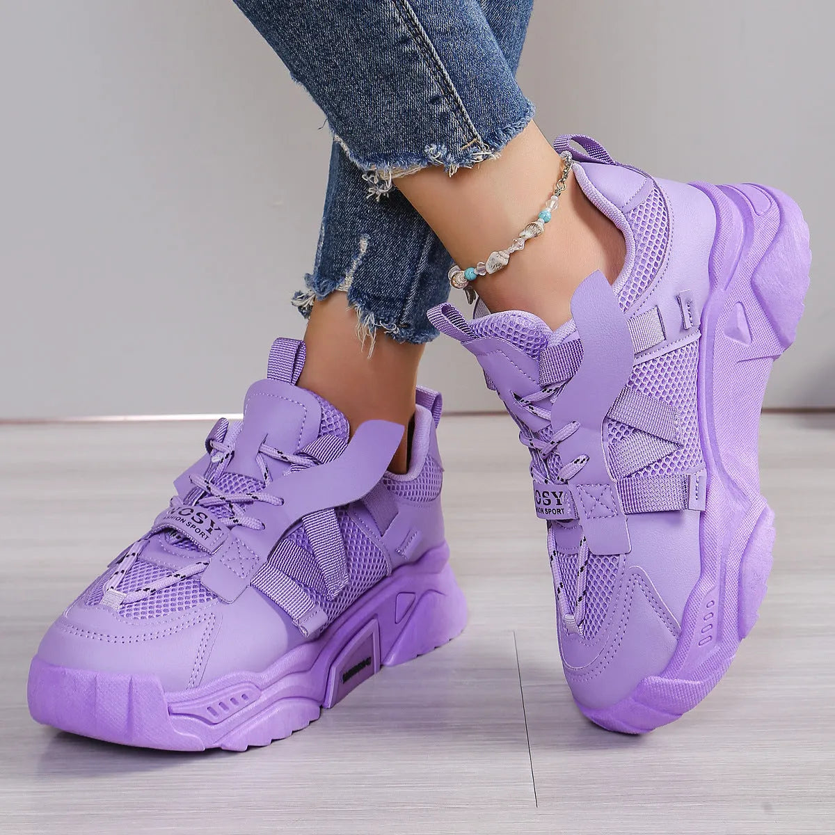 Women's purple platform sneaker with breathable mesh upper and lace-up front on a neutral background.