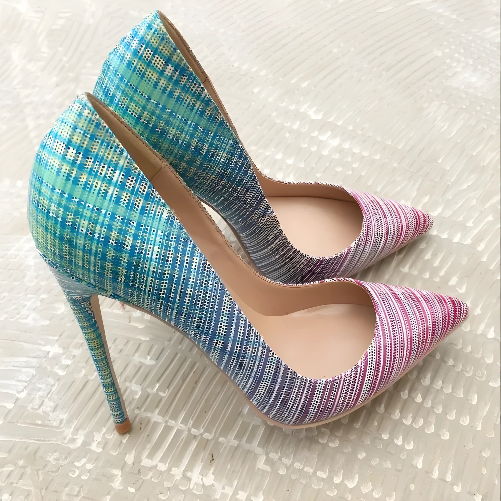 Women's pointed toe gradient colour patent leather stiletto heels on a rubber sole, shown in a shallow court shoe style.