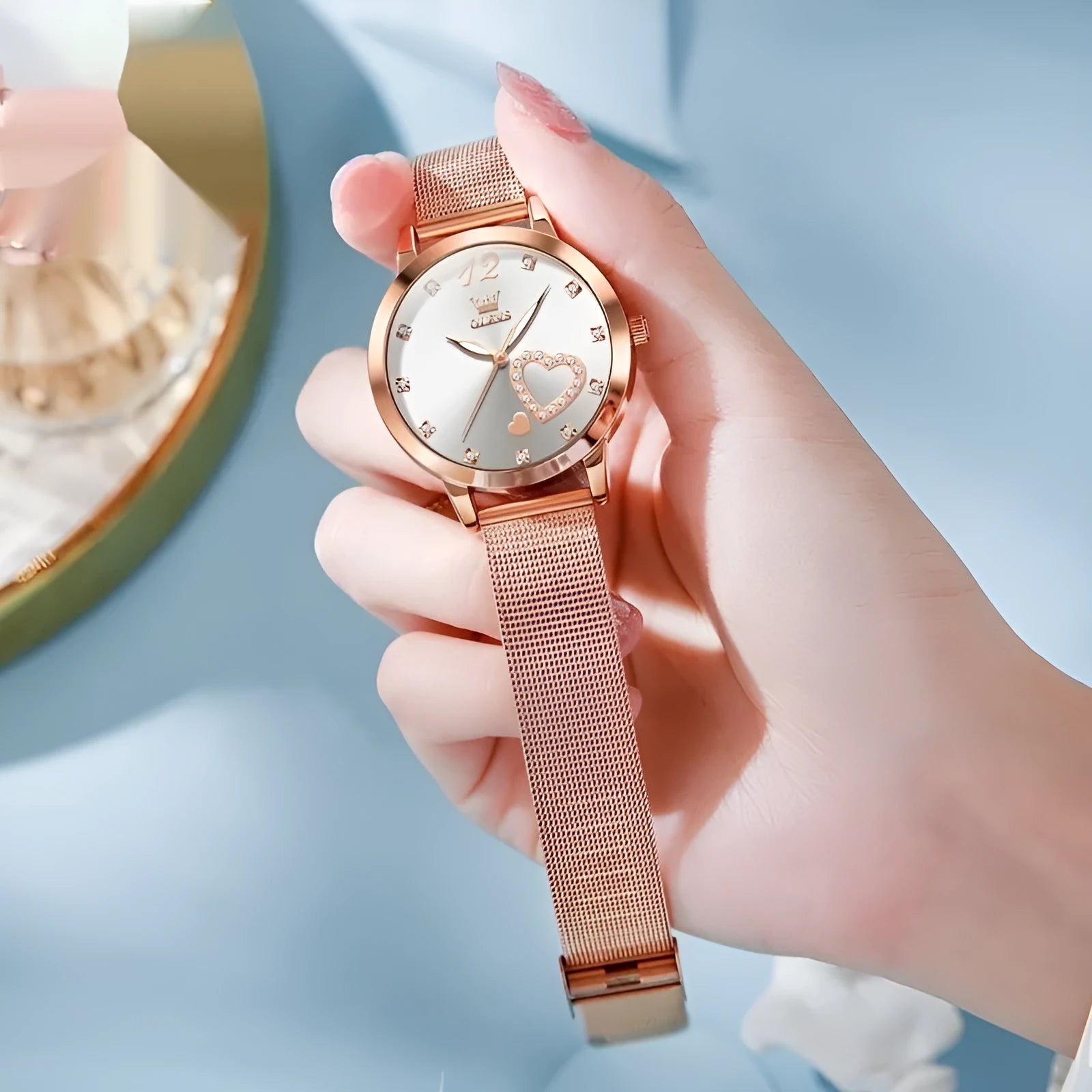Women's rose gold fashion watch with mesh strap showing six dial colour options