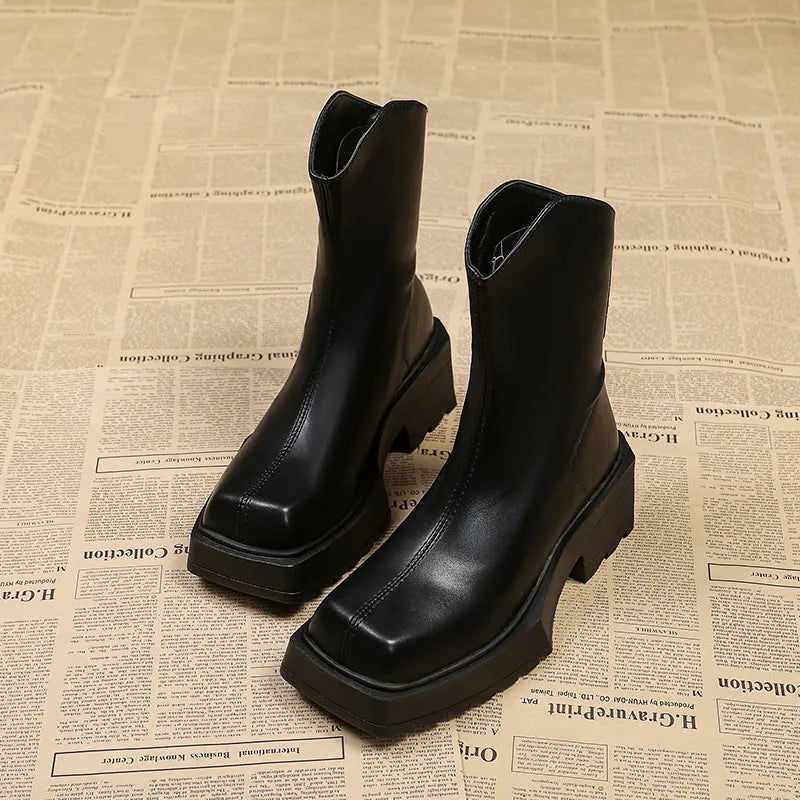 Black platform Martin boots for women with a square toe, mid calf length, and a high heel.