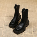 Black platform Martin boots for women with a square toe, mid calf length, and a high heel.