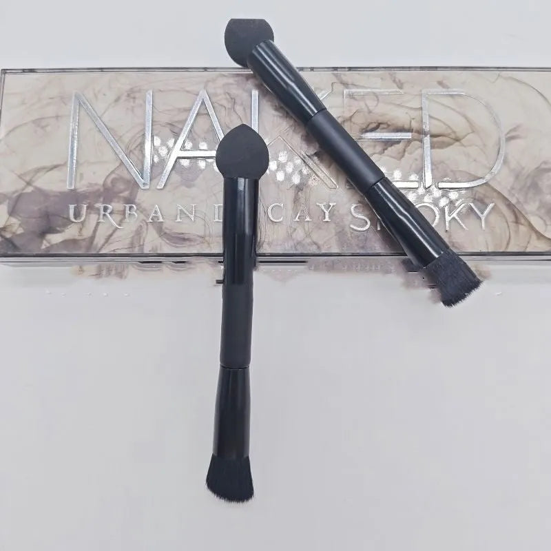 Black sponge tip concealer brush with a wooden handle for applying makeup to dark circles.