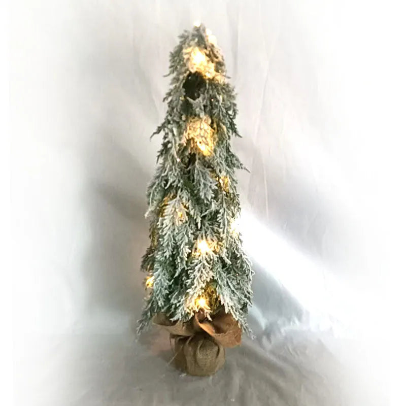Small 24-inch artificial Christmas tree with battery-powered lights and PE simulated snow spray on branches