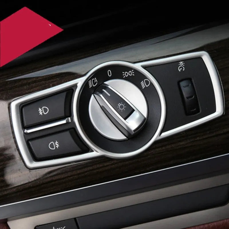 Silver ABS plastic decorative sticker for BMW headlight switch frame interior trim.