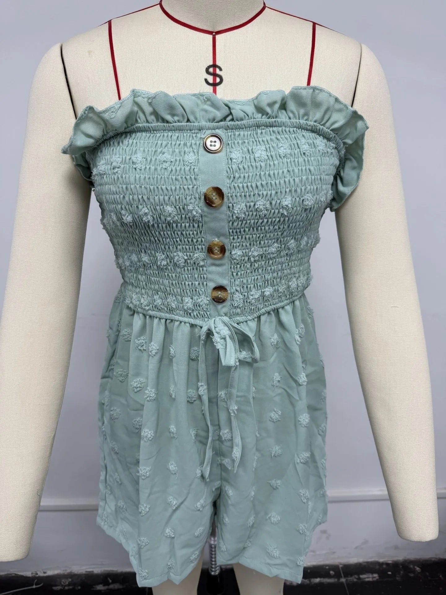 Women's blue off-shoulder jumpsuit with button detail and fifth pants length