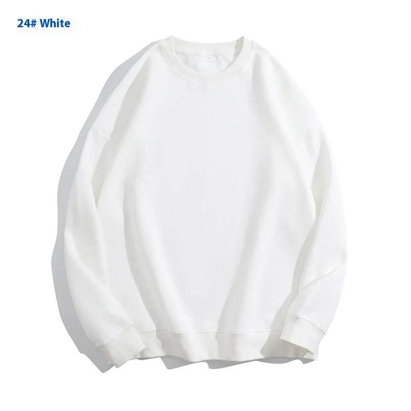 A loose-fitting, off-shoulder cotton sweater in a solid colour with long sleeves and a round neck.