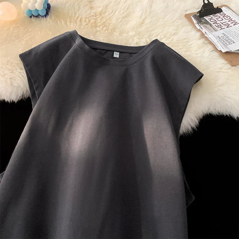 Men's loose solid colour sleeveless cotton tank top on a hanger, shown in a light apricot shade.