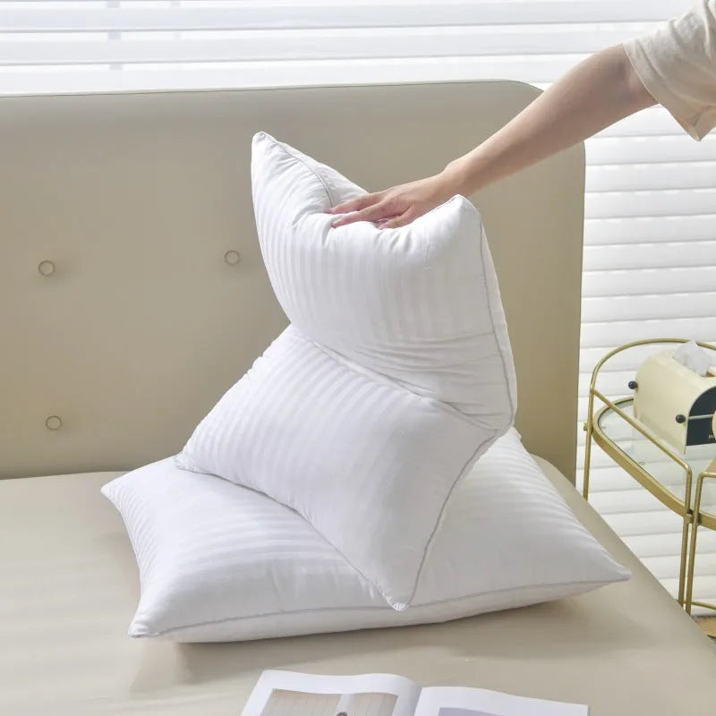 White cotton feather pillow with satin stripe detail, shown in low, medium, and high loft options.